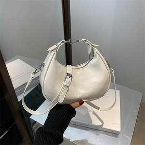 Minimalist white half-moon hobo bag with silver hardware and adjustable shoulder strap