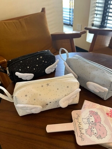 Detailed view of canvas star pencil cases with plush wings and zipper handles