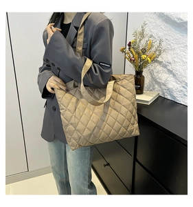 Detailed view of khaki quilted tote bag featuring a padded diamond lattice pattern finish