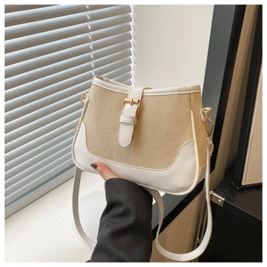 Detail of vintage woven crossbody bag featuring contrast leather trim and golden buckle