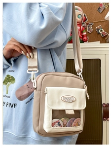 Gros plan sur un sac ita en toile beige avec fenêtre transparente et sangle large