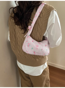 Detail of the pink floral bubble textured fabric and decorative knot on the shoulder bag