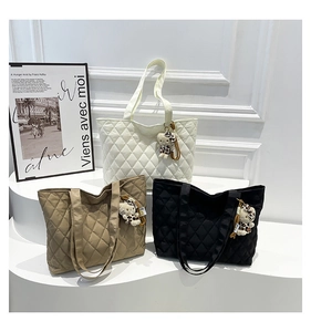 Three oversized quilted tote bags in white, khaki, and black with trendy cat charms