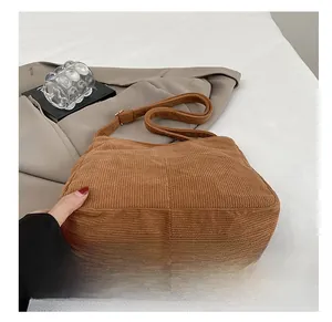 Detail view showing wear-resistant bottom and texture of corduroy shoulder tote bag