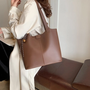 Retro dark brown leather tote bag with woven rope charm and golden bell decoration