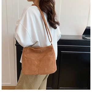 Brown corduroy tote bag detail showing vertical stripe texture and large capacity style