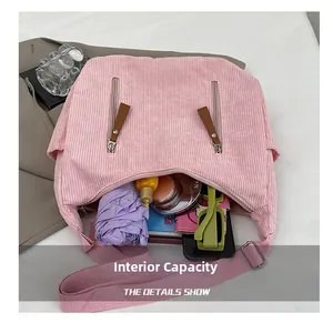 Detail shot of pink corduroy crossbody bag showing large capacity for daily items