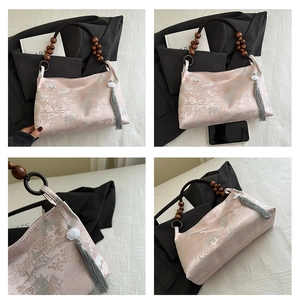 Detail of pink silk bag with Chinese embroidery, wooden bead handle and stylish tassel