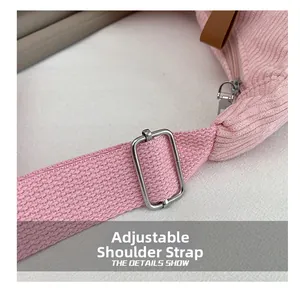 Pink corduroy crossbody bag featuring an adjustable shoulder strap and silver metal buckle