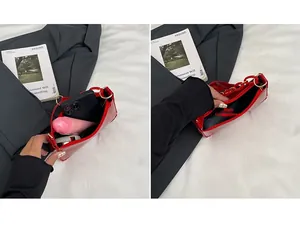 Detailed interior of red patent leather shoulder bag showing the main pocket capacity