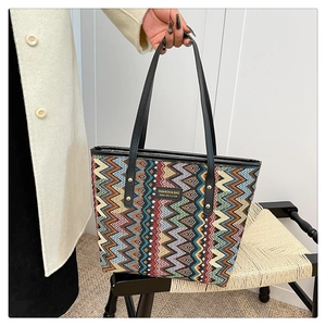 Detail of multi-color wavy knit pattern and fashion logo patch on ethnic tote bag