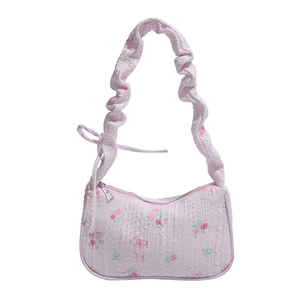 Pink floral drawstring underarm bag with ruffled strap and vintage rose patterns