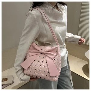 Detail of light pink seersucker tote bag with large bow and black butterfly embroidery