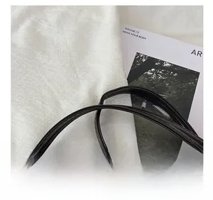 Detail of adjustable glossy oil wax leather shoulder strap for a fashion square handbag