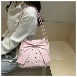 Close-up of pink seersucker tote bag featuring a large bow and textured bubble fabric detail