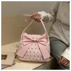 Detail of light pink bubble gauze tote bag with large bow and black butterfly patterns