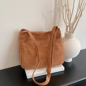 Brown corduroy tote bag with adjustable shoulder strap and large front pocket detail
