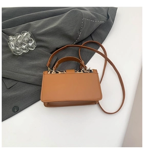 Détail du rabat à motif léopard sur un petit sac à main vintage en cuir marron