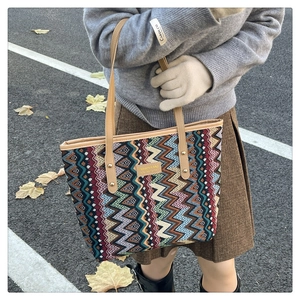 Close-up of bohemian large capacity tote bag with ethnic pattern and leather handle