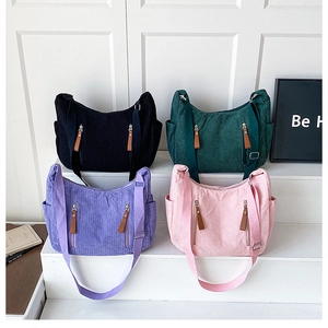 Corduroy dumpling bags in four colors with textured fabric and leather pull tabs
