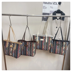 Detailed display of four large ethnic tote bags with zigzag patterns and metal rivet straps