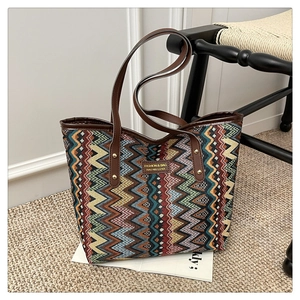 Close-up of bohemian zigzag woven tote bag with premium leather handles and brand label