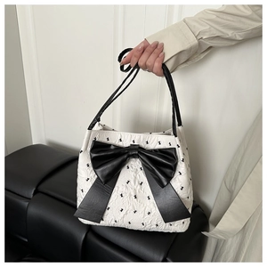 Detailed close-up of seersucker tote bag with large black bow and rabbit pattern