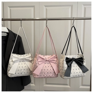 Detail view of large bow tote bags in seersucker fabric and multiple pastel colors