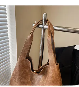 Detail of retro brown tote bag with oily leather texture and wide comfortable handle