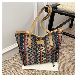 Detailed view of large ethnic striped tote bag with leather straps and geometric pattern