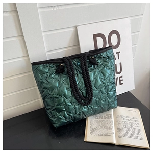 Détail du sac cabas matelassé vert foncé avec coutures étoiles et anses en corde