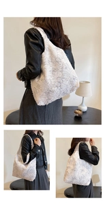 Detail of white tote bag featuring 3D floral lace texture and comfortable wide shoulder strap
