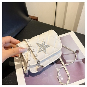 Close-up of white quilted square bag with star rhinestone and metal chain strap