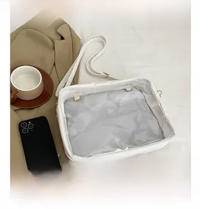 Detail view of white PU leather crossbody bag with transparent window for pins
