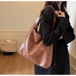 Side view of a vintage brown large capacity tote bag with textured faux leather finish