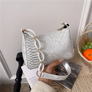 White snakeskin embossed underarm bag with gold chain and textured leather strap
