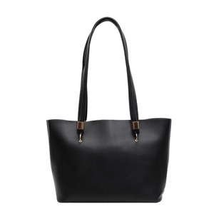 Minimalist black tote bag with long shoulder straps and gold metal buckles for daily commute