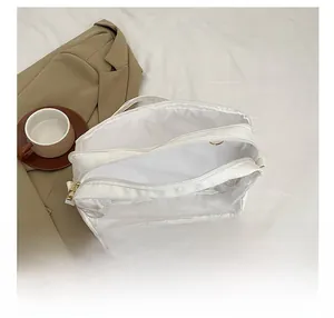 Detail of white semi-transparent double-layer storage bag with dual zipper closure