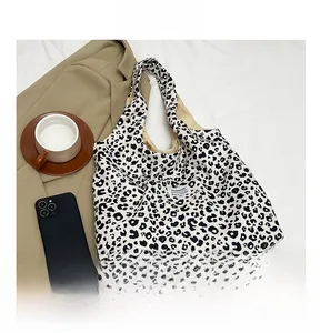 Detail of vintage leopard print tote bag with FASHION label and spacious canvas interior