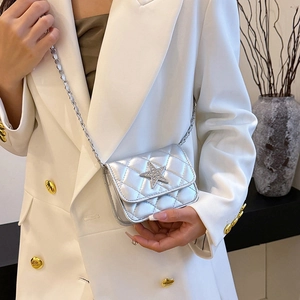 Silver quilted mini chain bag with star crystal detail over a white suit jacket