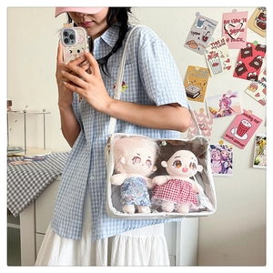 Detailed view of a white Japanese style ita bag with transparent window and plush dolls