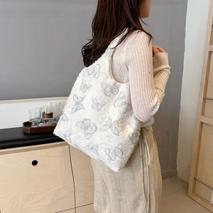 Chic oversized white tote bag featuring gray butterfly embroidery and fringe detailing