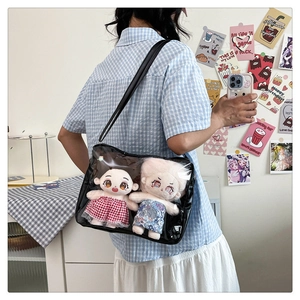 Detail view of transparent Ita bag showing internal storage for two anime plush dolls
