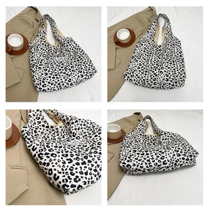 Detail view of large canvas tote bag with black and white leopard print and fashion tag