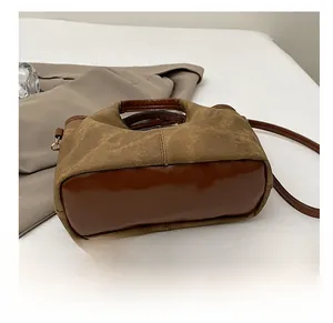 Detail view of durable leather bottom and stitching on a vintage patchwork handbag