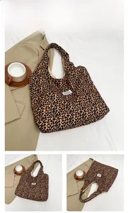 Detailed close-up of leopard print canvas tote bag with a white fashion label tag