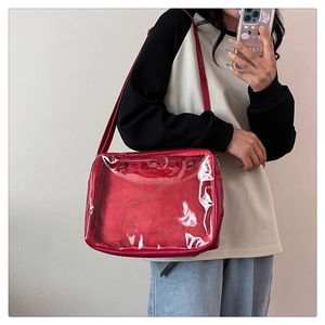 Detail of red Ita bag featuring a clear PVC window for pin and badge display