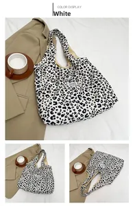 Detail view of large white leopard print tote bag with stylish logo label and inner lining