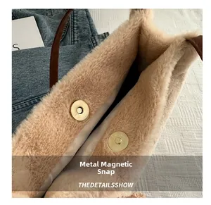 Detail view of the secure double magnetic buckles on this beige fuzzy faux fur tote bag
