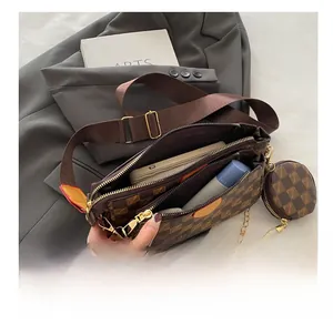 Detail view of coffee checkered crossbody bag showing interior storage and multi-compartments